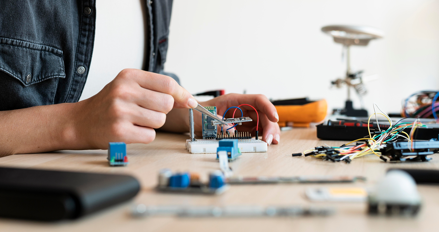 A builder working on an Arduino board