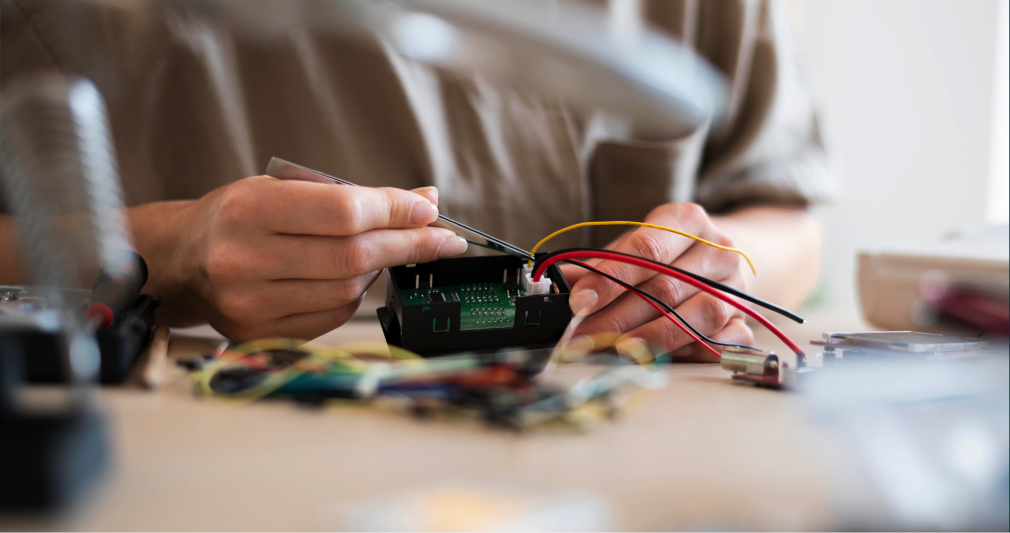 Hands assembling electronics